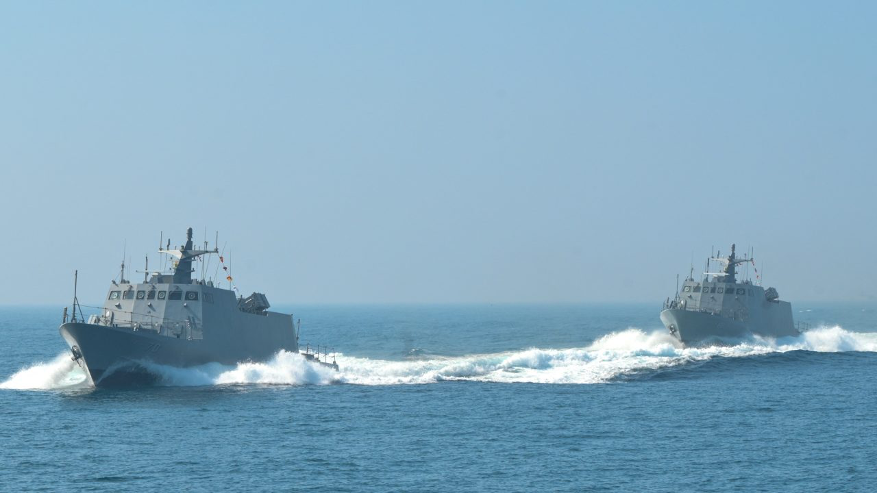 Military warships conducting exercises at sea